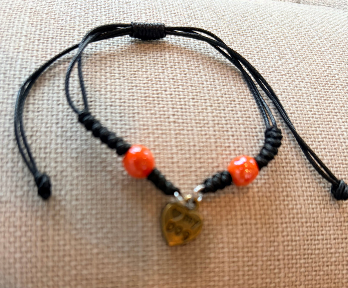 Lure Bracelet with blue and orange colors featuring a heart charm and beaded accents on a string.