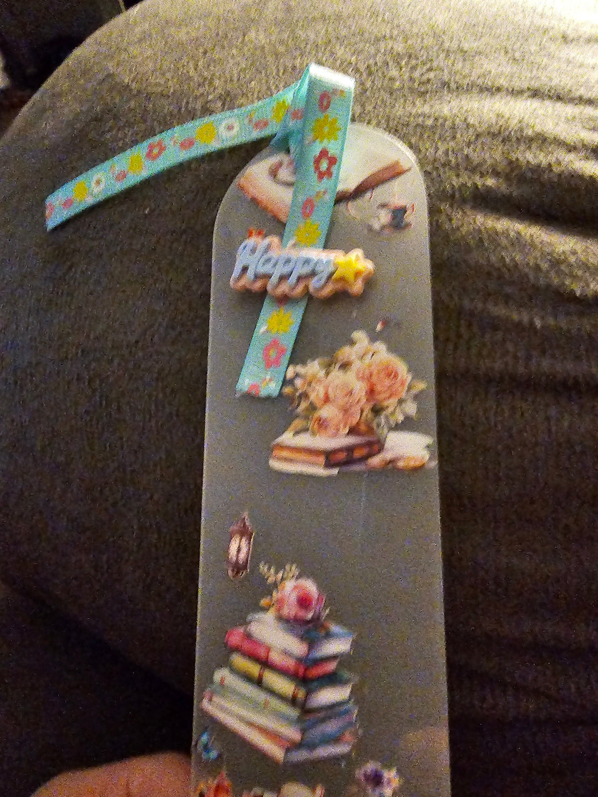 Decorative Handmade Unique Book Charm Bookmark  with colorful ribbon and illustrations on a textured surface